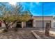 Single-story home with a gray garage door and landscaped front yard at 3921 W Sharon Ave, Phoenix, AZ 85029