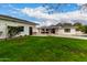 Spacious backyard with grassy lawn and partial view of pool and patio at 4017 E Wilshire Dr, Phoenix, AZ 85008