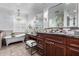 Luxurious bathroom with soaking tub, double vanity, and dark wood cabinets at 4017 E Wilshire Dr, Phoenix, AZ 85008