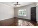 Bright bedroom featuring hardwood floors and plantation shutters at 4017 E Wilshire Dr, Phoenix, AZ 85008