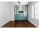 Bedroom with hardwood floors, built-in shelving, and window shutters at 4017 E Wilshire Dr, Phoenix, AZ 85008