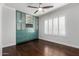 Bedroom with hardwood floors, built-in shelving, and window shutters at 4017 E Wilshire Dr, Phoenix, AZ 85008