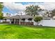 House exterior showcasing a large lawn, mature trees, and basketball hoop at 4017 E Wilshire Dr, Phoenix, AZ 85008