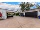 View of the two-car garage and covered patio with seating at 4017 E Wilshire Dr, Phoenix, AZ 85008