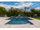 Stunning pool with cascading water feature and expansive deck at 4017 E Wilshire Dr, Phoenix, AZ 85008