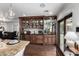 Elegant wet bar features dark wood cabinetry, granite counters, and wine storage at 4017 E Wilshire Dr, Phoenix, AZ 85008