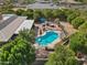 Aerial view showcasing a backyard with pool, brick fireplace, lush greenery, and charming outdoor entertaining area at 4024 E Hermosa Vista Dr, Mesa, AZ 85215