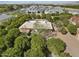 Expansive aerial view of a home with a pool surrounded by lush greenery in a peaceful neighborhood at 4024 E Hermosa Vista Dr, Mesa, AZ 85215