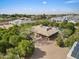 An aerial view showcases a beautiful property with a pool, mature trees, and a brick driveway in a serene setting at 4024 E Hermosa Vista Dr, Mesa, AZ 85215