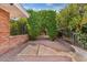 Charming brick-paved backyard with lush greenery and wrought iron accents, perfect for outdoor relaxation and privacy at 4024 E Hermosa Vista Dr, Mesa, AZ 85215