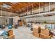 Unfinished basement space with exposed wood beams, concrete floors, and built-in shelving for storage at 4024 E Hermosa Vista Dr, Mesa, AZ 85215