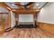 Finished basement featuring wood flooring, exposed beams, and a brick wall with a projector screen at 4024 E Hermosa Vista Dr, Mesa, AZ 85215