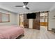 This bedroom features a sliding barn door to the bathroom and laminate wood flooring at 4024 E Hermosa Vista Dr, Mesa, AZ 85215