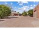 Wide concrete brick driveway leading to a charming home with mature trees and detached garage at 4024 E Hermosa Vista Dr, Mesa, AZ 85215