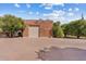 Detached garage with brick exterior and large roll-up door and concrete brick driveway at 4024 E Hermosa Vista Dr, Mesa, AZ 85215