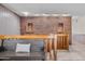 Inviting hallway featuring a cozy bench, wood railing, and decorative brick wall at 4024 E Hermosa Vista Dr, Mesa, AZ 85215