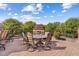 Backyard brick patio with outdoor dining set, fireplace and landscaped views at 4024 E Hermosa Vista Dr, Mesa, AZ 85215