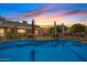 Inviting in-ground pool with sunset views and a brick house, perfect for enjoying warm evenings in a backyard oasis at 4024 E Hermosa Vista Dr, Mesa, AZ 85215