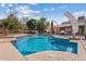 Beautiful in-ground pool surrounded by lush landscaping and ample patio space for relaxing and entertaining at 4024 E Hermosa Vista Dr, Mesa, AZ 85215