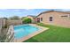 Private backyard with a sparkling pool and artificial turf at 4125 W Bradshaw Creek Ln, New River, AZ 85087