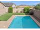 Inviting backyard oasis featuring a sparkling pool, lush grass, and mountain views at 4125 W Bradshaw Creek Ln, New River, AZ 85087