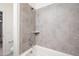 Clean bathroom with shower and tiled walls at 4125 W Bradshaw Creek Ln, New River, AZ 85087