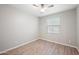 Well-lit bedroom with ceiling fan and wood-look floors at 4125 W Bradshaw Creek Ln, New River, AZ 85087