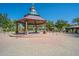 Quaint gazebo with clock tower, brick flooring, and surrounding park at 4125 W Bradshaw Creek Ln, New River, AZ 85087