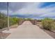 Landscaped pathway with a footbridge crossing a waterway at 4125 W Bradshaw Creek Ln, New River, AZ 85087