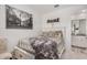 Bright bedroom with a comfy bed, en-suite bathroom, and large picture at 4134 E Pinto Dr, Gilbert, AZ 85296