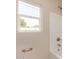 Bathroom with a bathtub, shower, and window at 414 E Eason Ave, Buckeye, AZ 85326