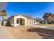 Newly built home with a tan colored front facade and driveway at 414 E Eason Ave, Buckeye, AZ 85326