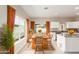 Modern kitchen featuring granite countertops, white cabinetry and a dining area at 414 E Eason Ave, Buckeye, AZ 85326