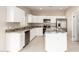 Modern kitchen featuring white shaker cabinets, granite countertops, and stainless steel appliances at 414 E Eason Ave, Buckeye, AZ 85326