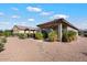 Covered patio, hot tub, and desert landscaping in the backyard at 41703 W Mesquite Rd, Maricopa, AZ 85138