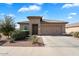 Single-story home with a two-car garage and landscaped front yard at 41703 W Mesquite Rd, Maricopa, AZ 85138