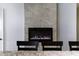 Modern electric fireplace with gray tile surround at 41703 W Mesquite Rd, Maricopa, AZ 85138