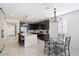 Open kitchen with island, dining area, and dark cabinets at 41703 W Mesquite Rd, Maricopa, AZ 85138