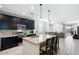 Open kitchen with island, granite counters, and dark cabinets at 41703 W Mesquite Rd, Maricopa, AZ 85138