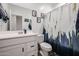 Clean bathroom with white vanity and a navy shower curtain at 4524 S 127Th Ln, Avondale, AZ 85323