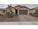 One-story home with a brown garage door and landscaped front yard at 4524 S 127Th Ln, Avondale, AZ 85323