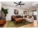 Living room with leather sofas, a coffee table, and a ceiling fan at 4950 N Miller Rd # 347, Scottsdale, AZ 85251