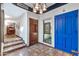 Inviting entryway with terracotta tile floors, a bright blue door, and a stained-glass window at 4979 E Calle De Los Arboles --, Cave Creek, AZ 85331