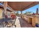 Outdoor kitchen with built-in grill, seating area, and pergola at 4979 E Calle De Los Arboles --, Cave Creek, AZ 85331