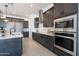 Modern kitchen with dark wood cabinets, stainless steel appliances, and an island at 508 W Tanya Rd, Phoenix, AZ 85086