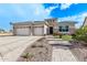 Single-story home with three-car garage, stone accents, and landscaped front yard at 5645 N Crow Dr, Eloy, AZ 85131