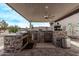 Outdoor kitchen with stone counters, grill, and pizza oven at 5645 N Crow Dr, Eloy, AZ 85131