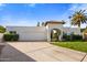 Single-story home with arched entryway and two-car garage at 5660 N 73Rd St, Scottsdale, AZ 85250