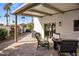 Covered patio with fire pit and seating overlooking yard at 5660 N 73Rd St, Scottsdale, AZ 85250