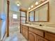 Bathroom with double vanity and pink tiled tub surround at 5708 W Belmont Ave, Glendale, AZ 85301